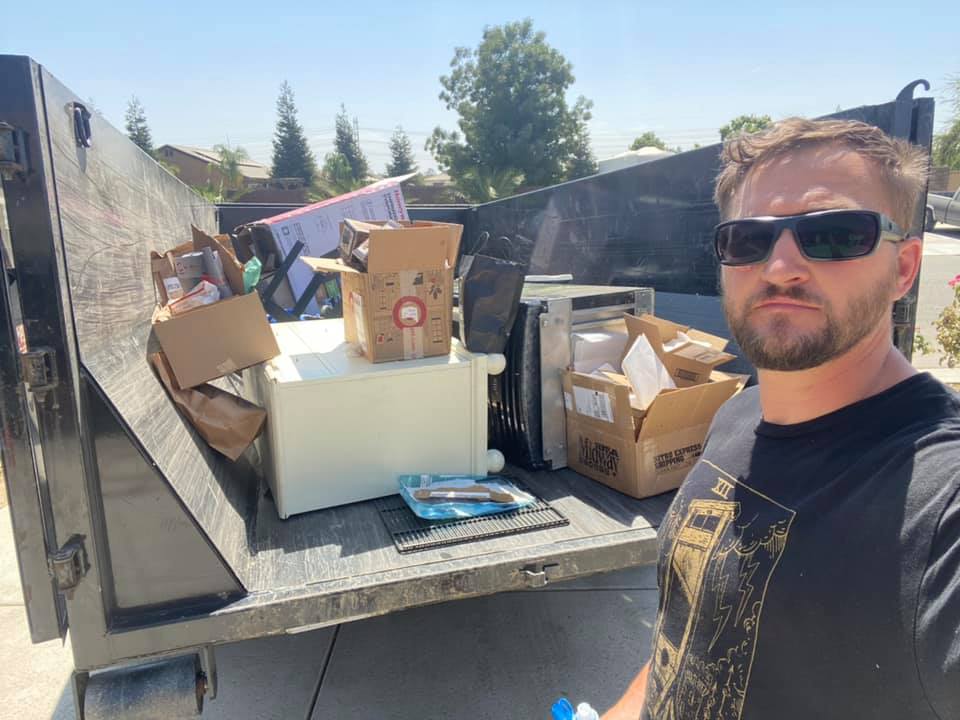 Bakersfield Roll Off owner standing beside a hydraulic dump trailer